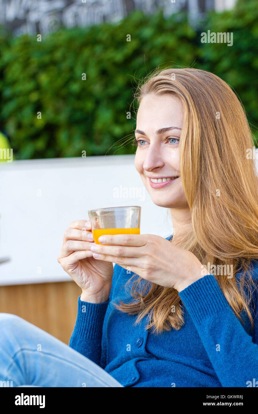 Woman with tea cup. Tea with sea buckthorn and honey on cafe background