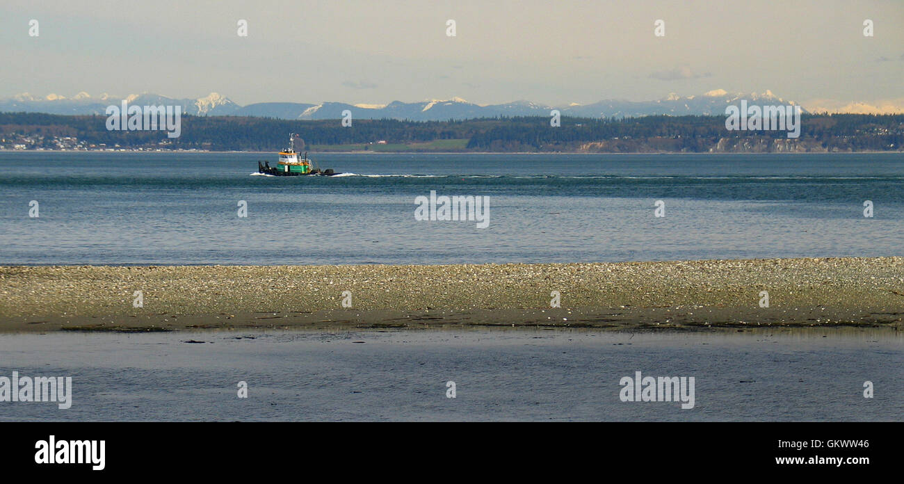 A small tugboat motors through the inland waterways of Puget Sound, north of Anecortes in Washington State, USA. Stock Photo