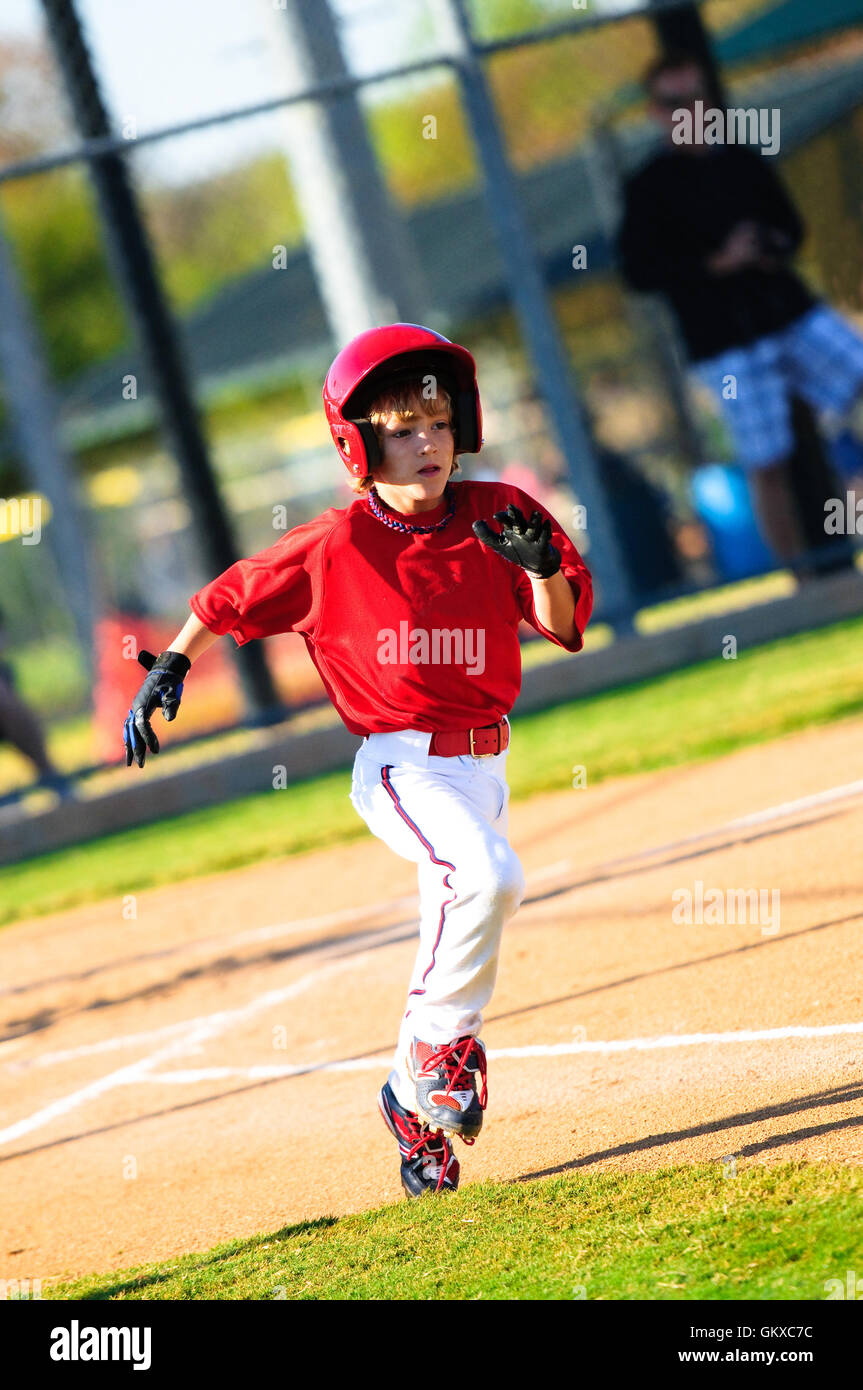 Young boy the batter running to first base during a Little League baseball  game Stock Photo - Alamy