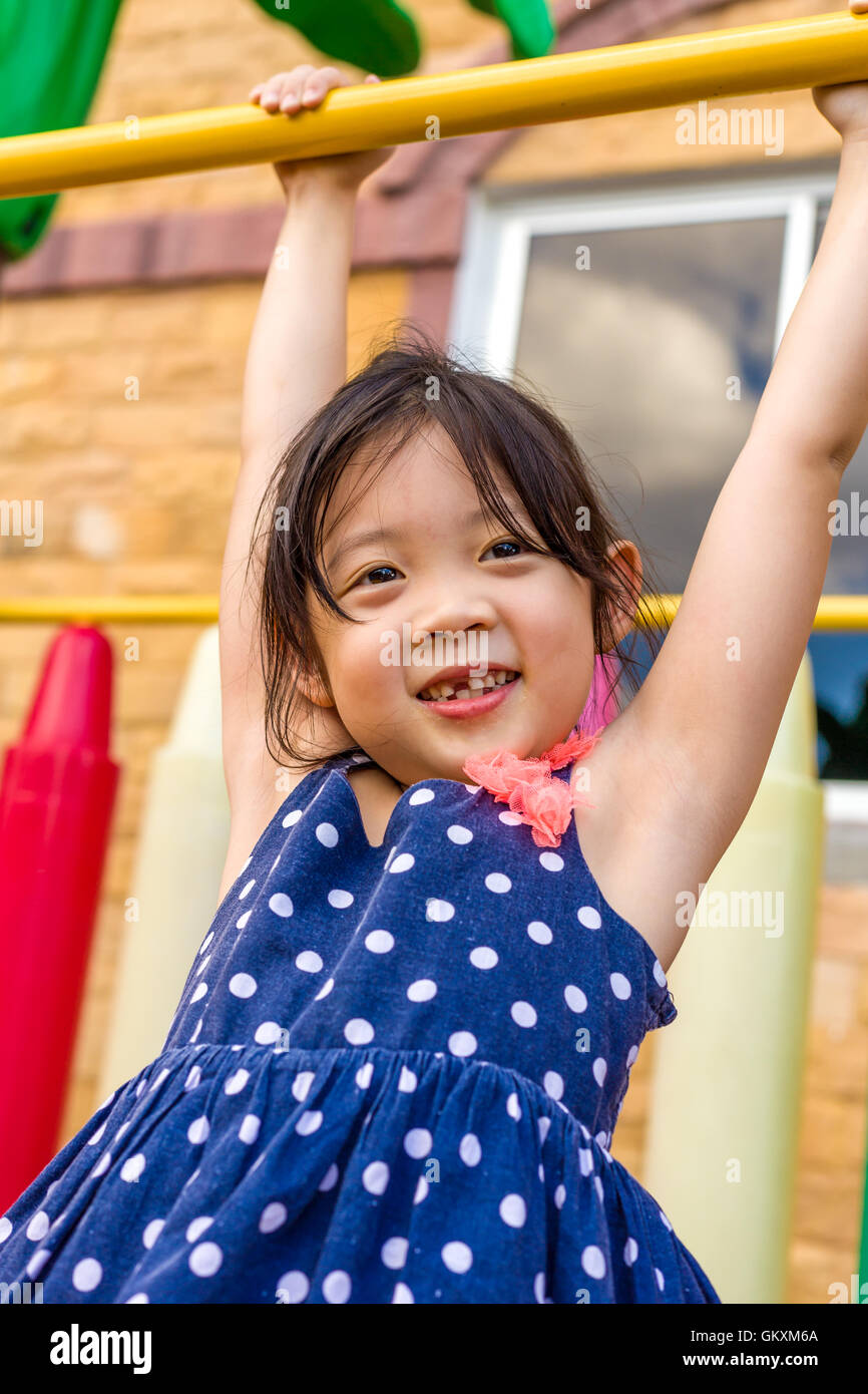 Young girl playing outdoor equipment with happiness Stock Photo Alamy