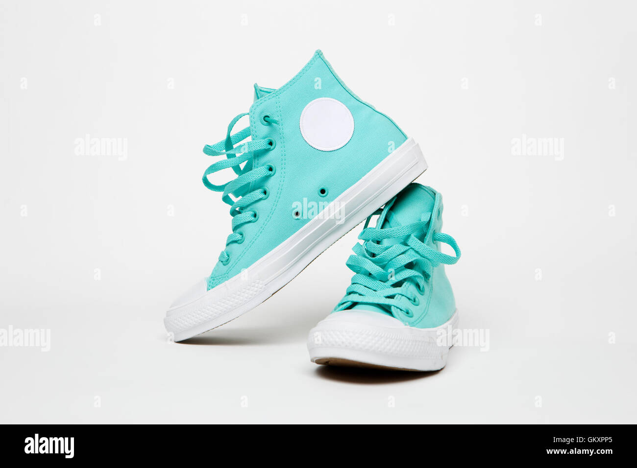 Turquoise sneakers on blank white background Stock Photo - Alamy
