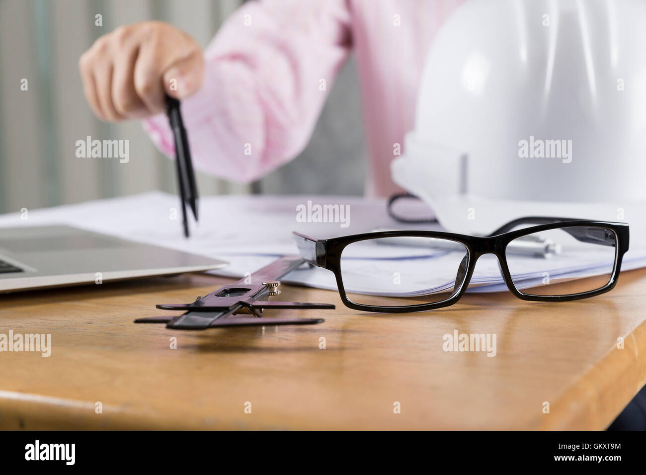 architect hand holding compass working on construction engineering