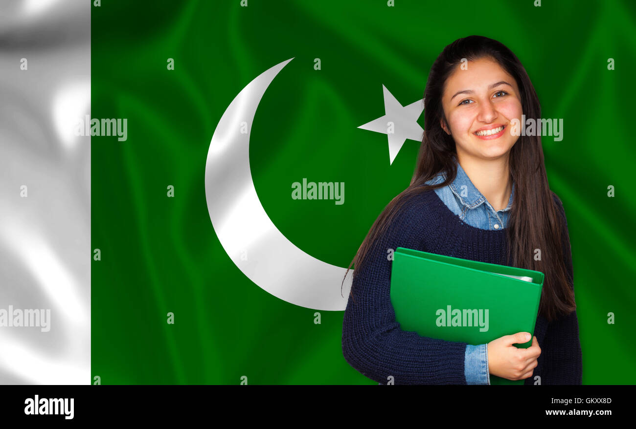 Teen student smiling over Pakistani flag. Concept of lessons and learning of foreign languages. Stock Photo