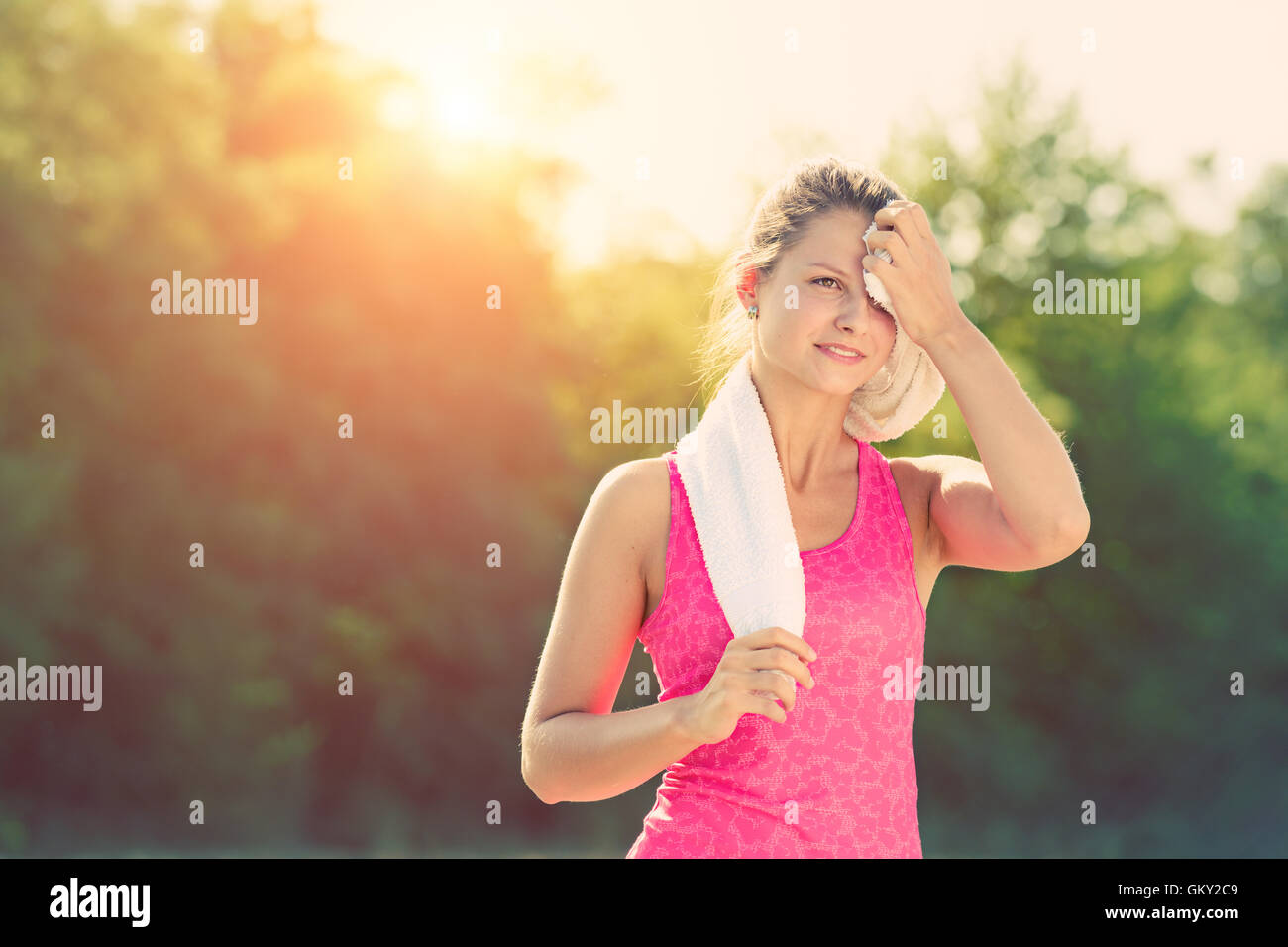 Attractive female taking a break after jogging Stock Photo Alamy