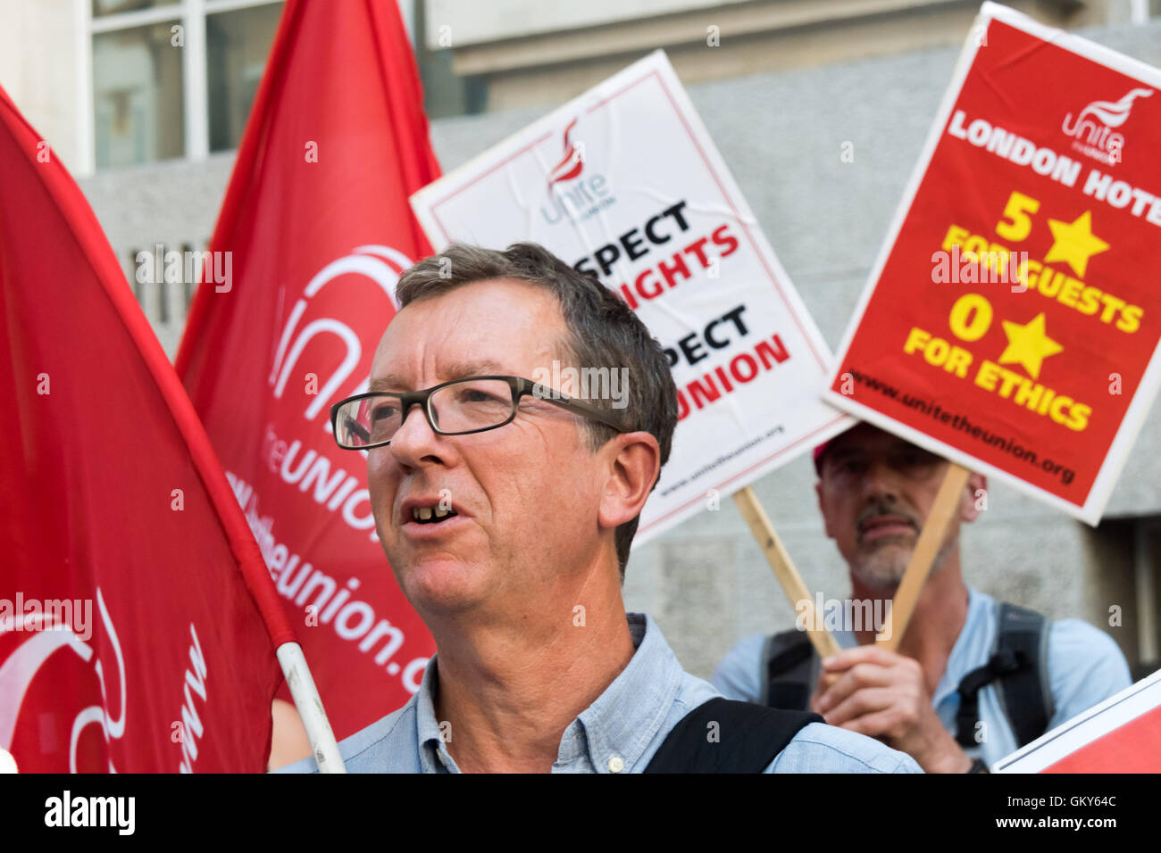 London, UK. August 23rd 2016. Unite London regional secretary Peter Kavanagh at the  protest outside the Premier Inn at London County Hall where the Hospitality Workers launch their 'Unethical London' report into the bullying, harassment and victimisation of workers in London's top hotels, where management deny the right to join unions and bargain for better wages and conditions. Two thirds of hospitality workers earn less than the London Living Wage. Peter Marshall/Alamy Live News Stock Photo