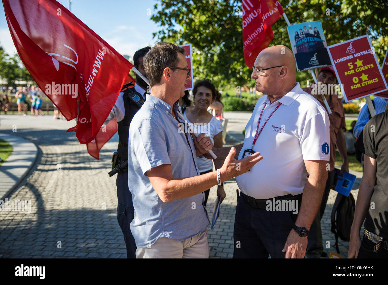 London, UK. 23rd August, 2016. A patrol officer from the Lambeth South Bank Patrol team pushes Peter Kavanagh, Unite London Regional Secretary, as he informs him that members of the Unite Hotel Workers Branch launching their Unethical London report are not permitted to display placards and banners in Jubilee Gardens. Credit:  Mark Kerrison/Alamy Live News Stock Photo