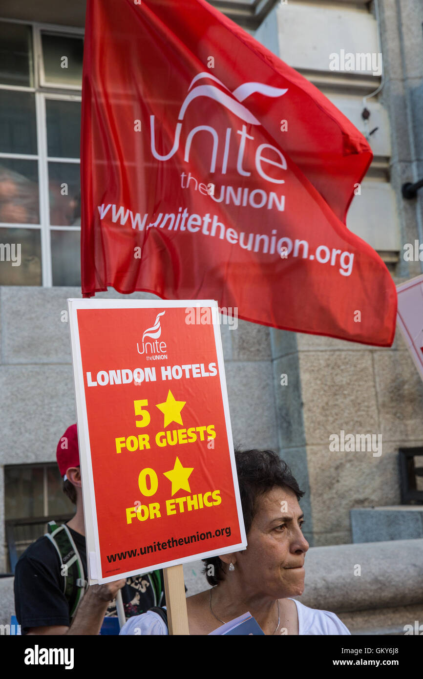 London, UK. 23rd August, 2016. A member of the Unite Hotel Workers Branch launches the Unethical London report, which details the manner in which workers at leading London hotels are denied access to the basic human rights of freedom of association and collective bargaining, at a protest outside the Premier Inn at Country Hall. Two-thirds of hospitality workers earn less than the London Living Wage. Credit:  Mark Kerrison/Alamy Live News Stock Photo