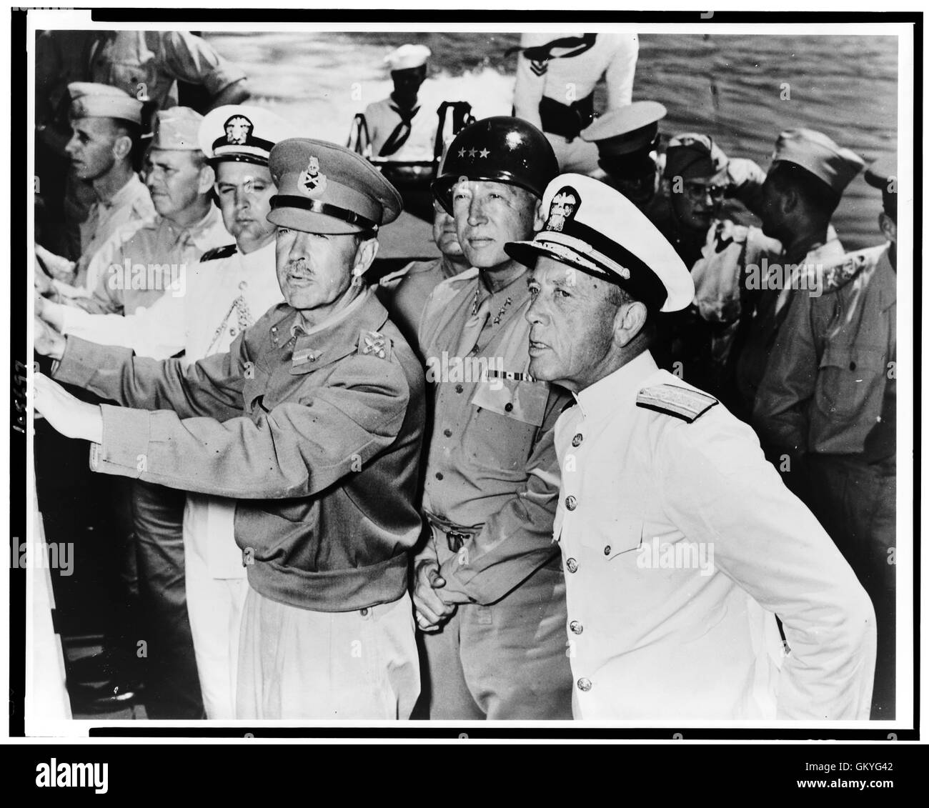 General Sir Harold Alexander, Lieut. General George S. Patton (center), and Rear Admiral Alan G. Kirk inspect an invasion task force off the coast of North Africa. Stock Photo