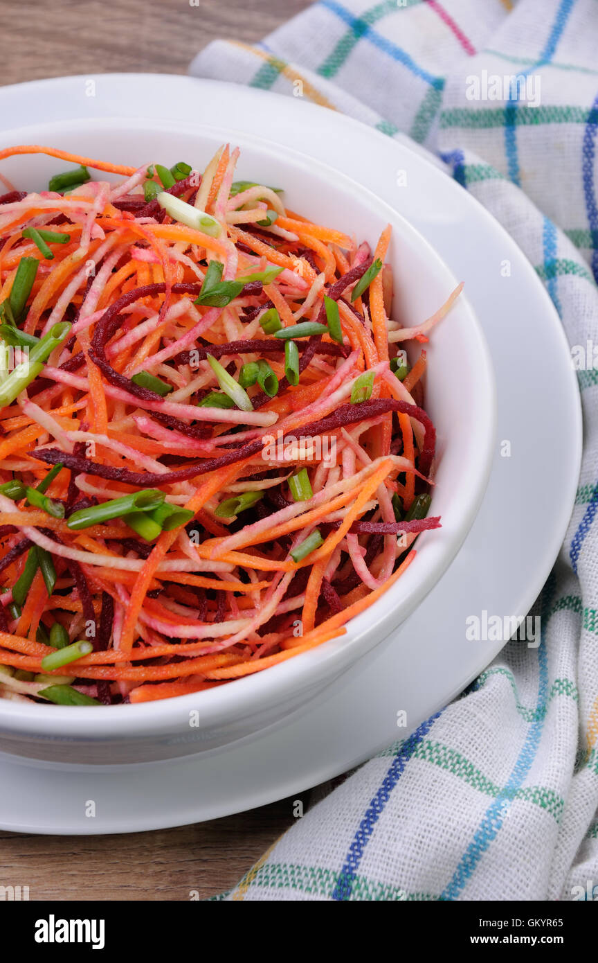 a plate salad of shredded raw beets, and carrots  on celery root Stock Photo