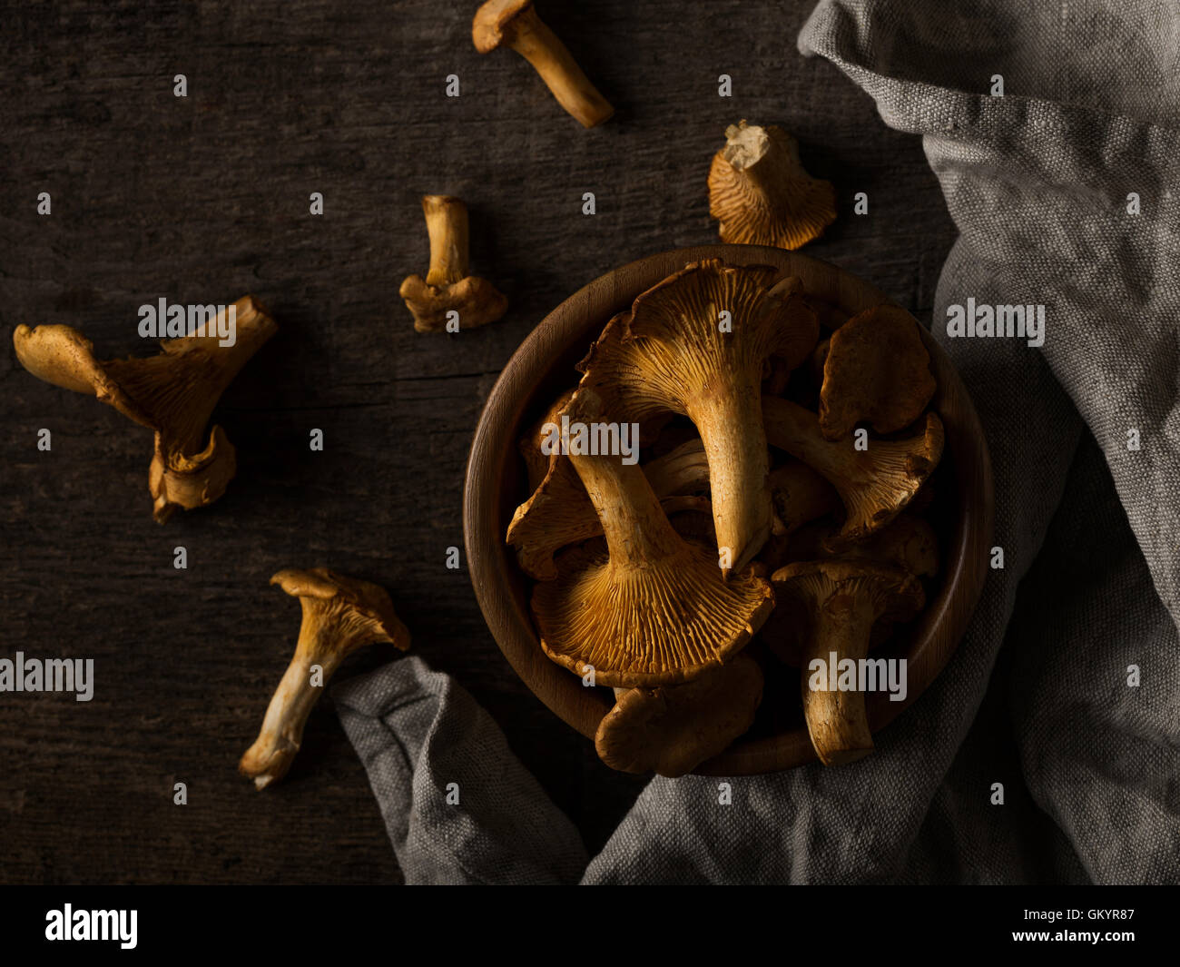 Dark rustic still life with bowl full of chanterelles on the rou Stock ...