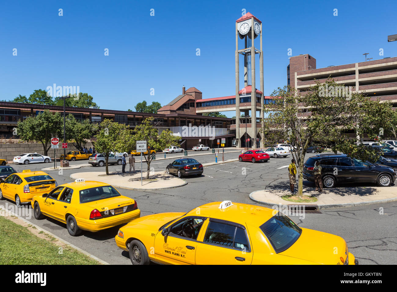 Taxis wait for passengers in the taxi line outside the White Plains Metro-North Railroad station in White Plains, New York. Stock Photo