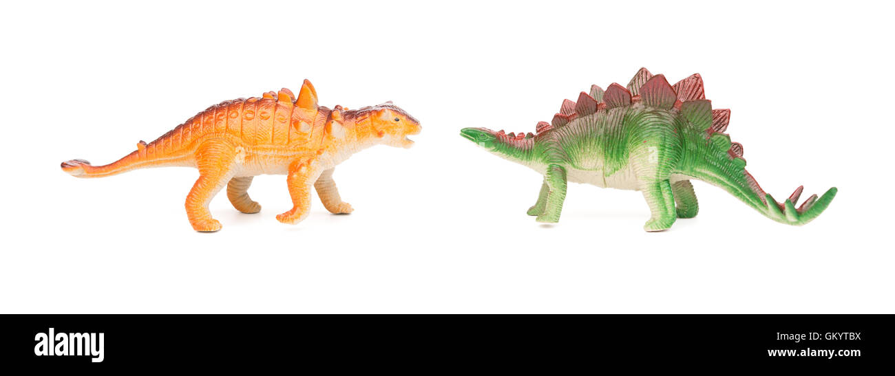 green stegosaurus and orange pinacosaurus toy on a white background