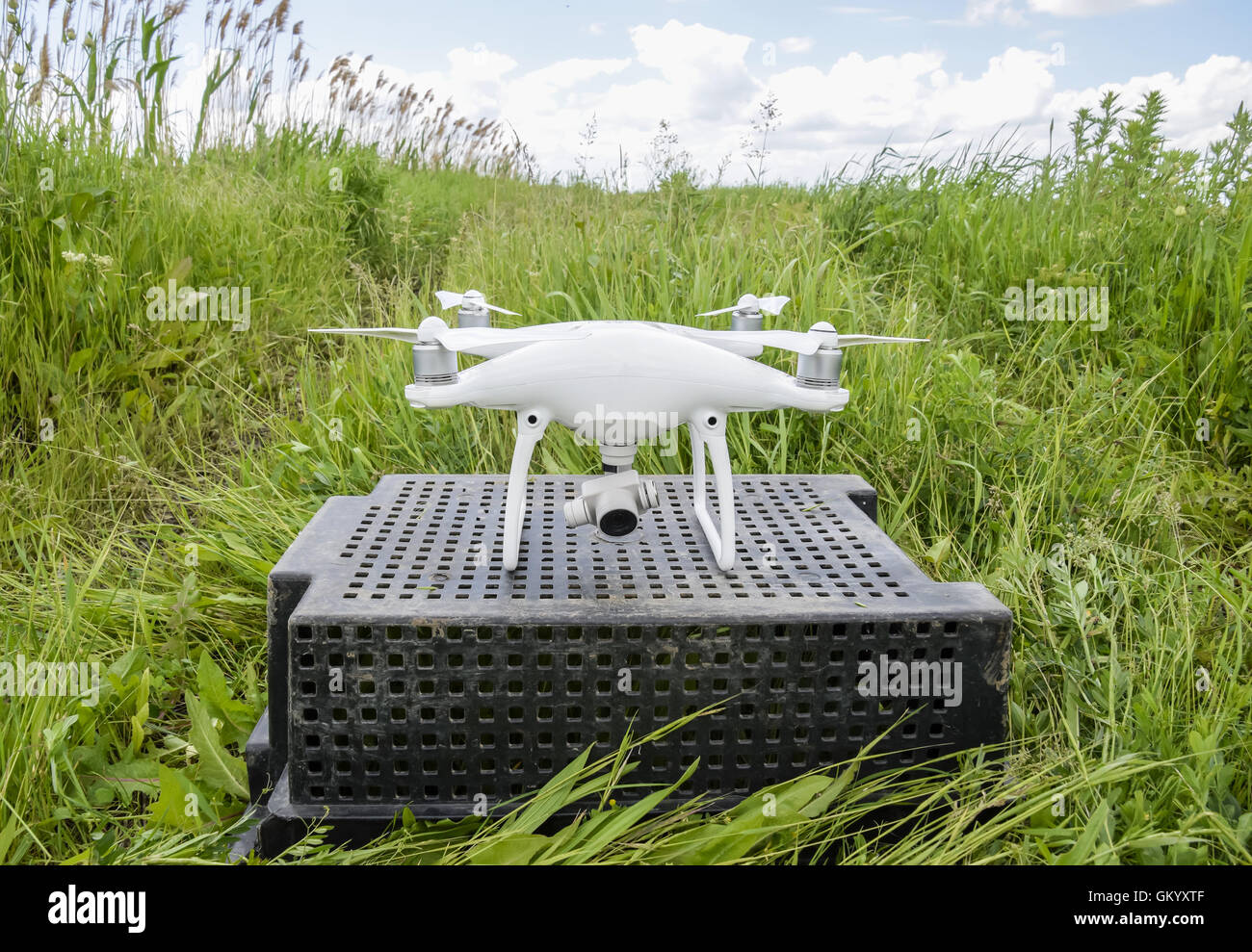Quadrocopters on a plastic box in the grass. Preparation quadrocopter to fly. Stock Photo