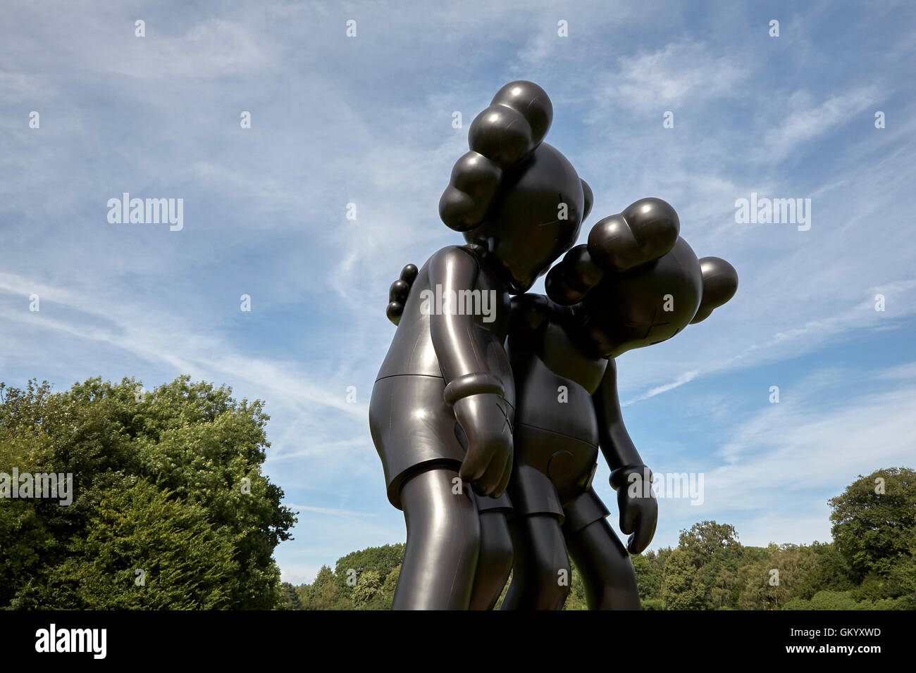 Kaws Along the Way black wooden sculpture in the Yorkshire Sculpture Park YSP Stock Photo