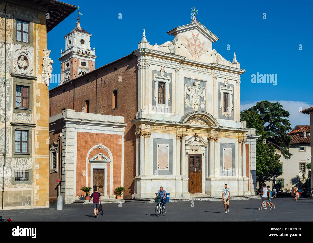 People walking in front of principal facade of Chiesa di Santo Stefano dei Cavalieri church in Piazza dei Cavalieri. Pisa. Stock Photo