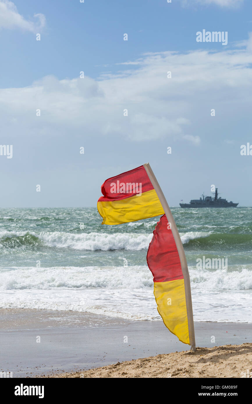 red and yellow flags indicating safe area to swim on Bournemouth beach in August Stock Photo