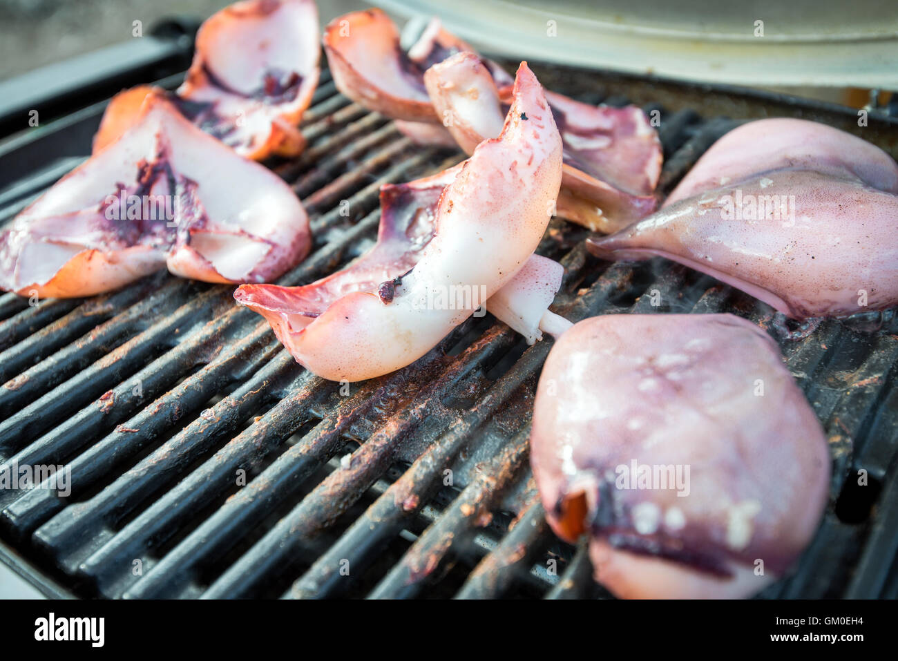 Delicious australian squid wings marinated with garlic sauce cooked on BBQ Stock Photo