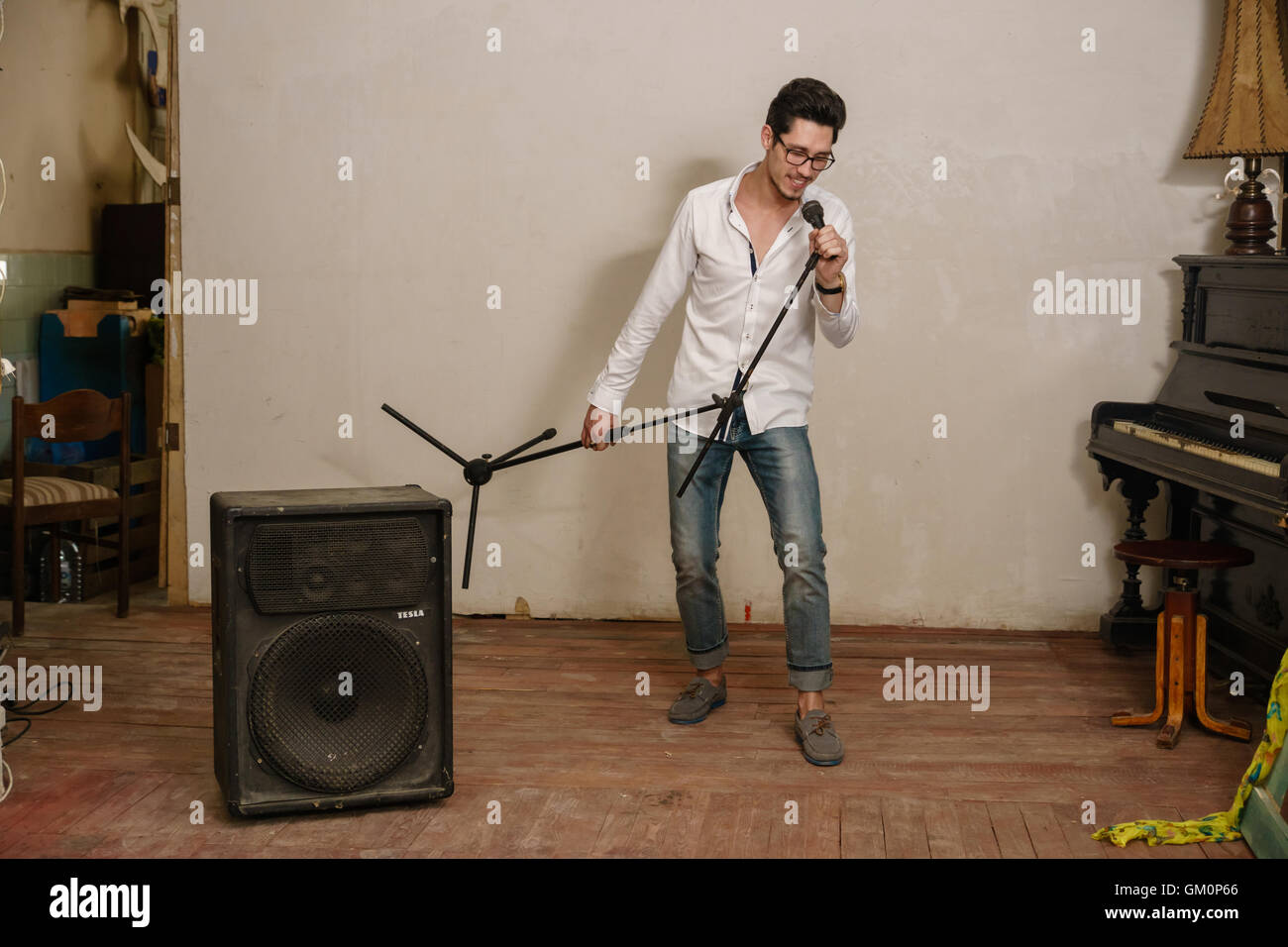 Brunet sings keeps the microphone in his hand and smiles Stock Photo