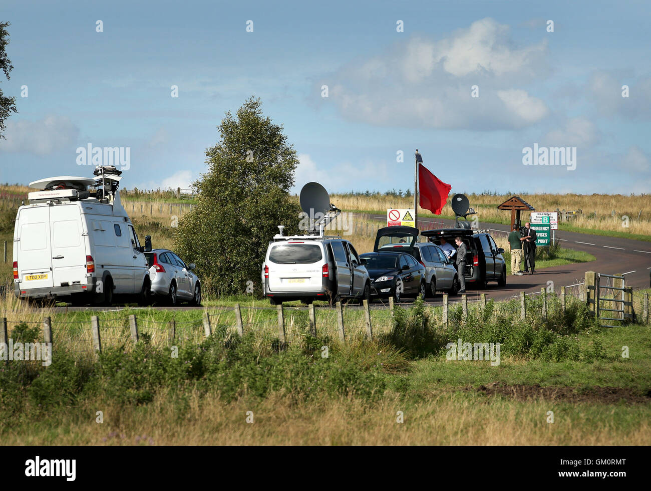 Media vans on the road leading to the entrance of the Otterburn Training Camp in Northumberland, where a soldier has died while taking part in a night live-firing exercise. Stock Photo