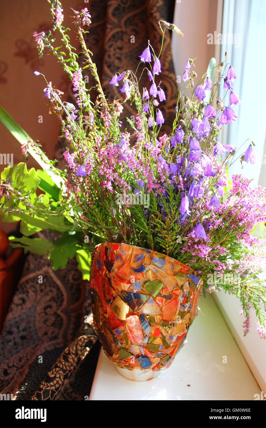 beautiful summer bright bouquet of wild field flowers in bloom stay in vase for decoration Stock Photo