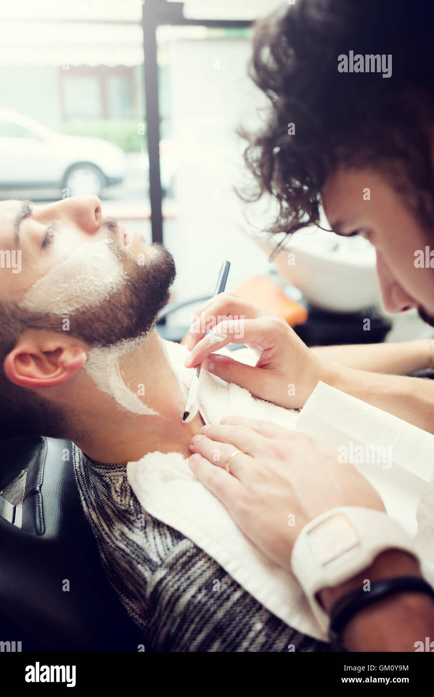 Traditional ritual of shaving the beard in a old style barber shop. Stock Photo