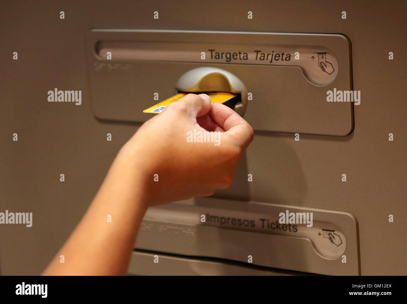 Using a credit card on a contactless system on a atm in Spain. Stock Photo