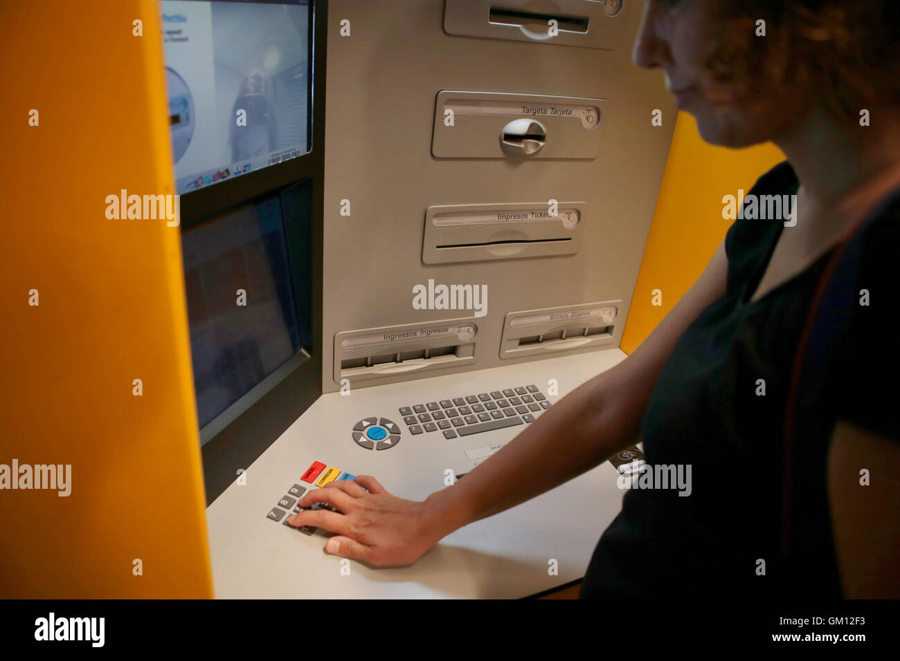 Using a credit card on a contactless system on a atm in Spain. Stock Photo