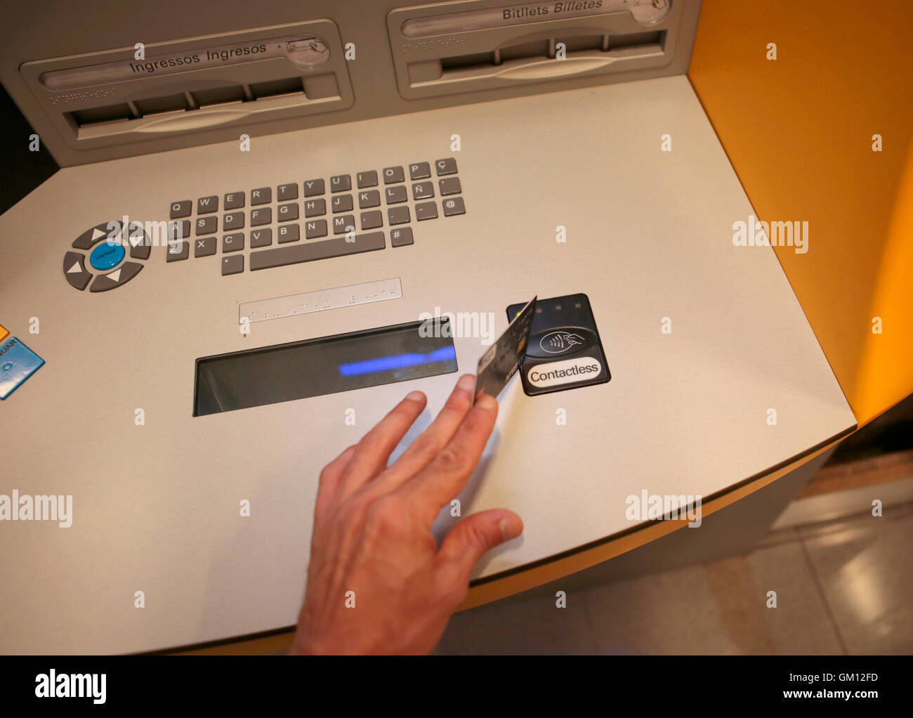 Using a credit card on a contactless system on a atm in Spain. Stock Photo