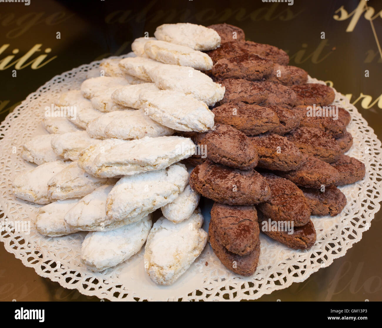 Ricciarelli typical biscuits of Tuscany, classic and chocolate.. Stock Photo