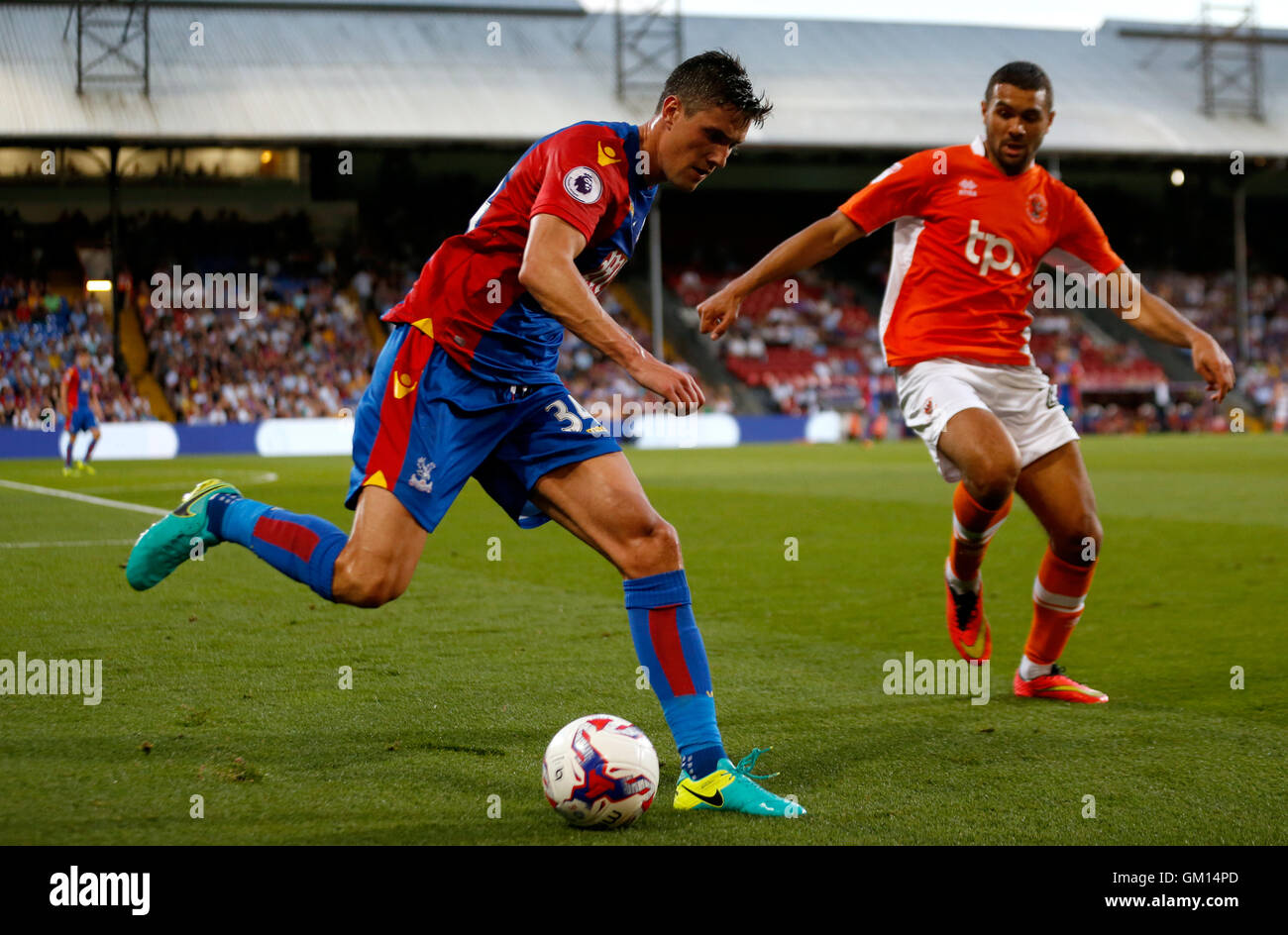 Crystal Palace's Martin Kelly (left) and Blackpool's Colin Daniel battle for the ball during the EFL Cup, Second Round match at Selhurst Park, London. Stock Photo