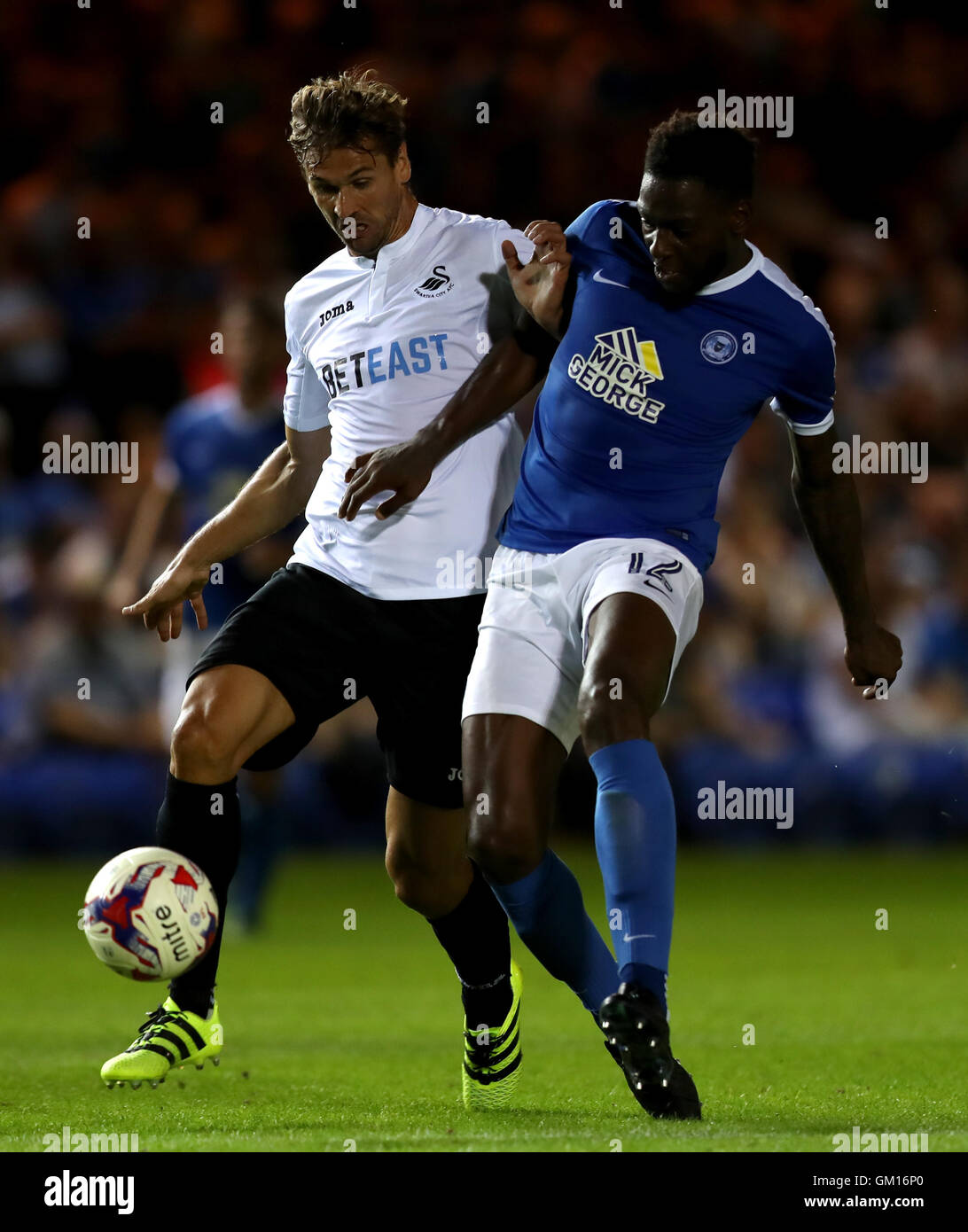 Swansea City's Federico Llorente (left) and Peterborough United's Ricardo Almeida Santos battle for the ball during the EFL Cup, Second Round match at the ABAX Stadium, Peterborough. Stock Photo