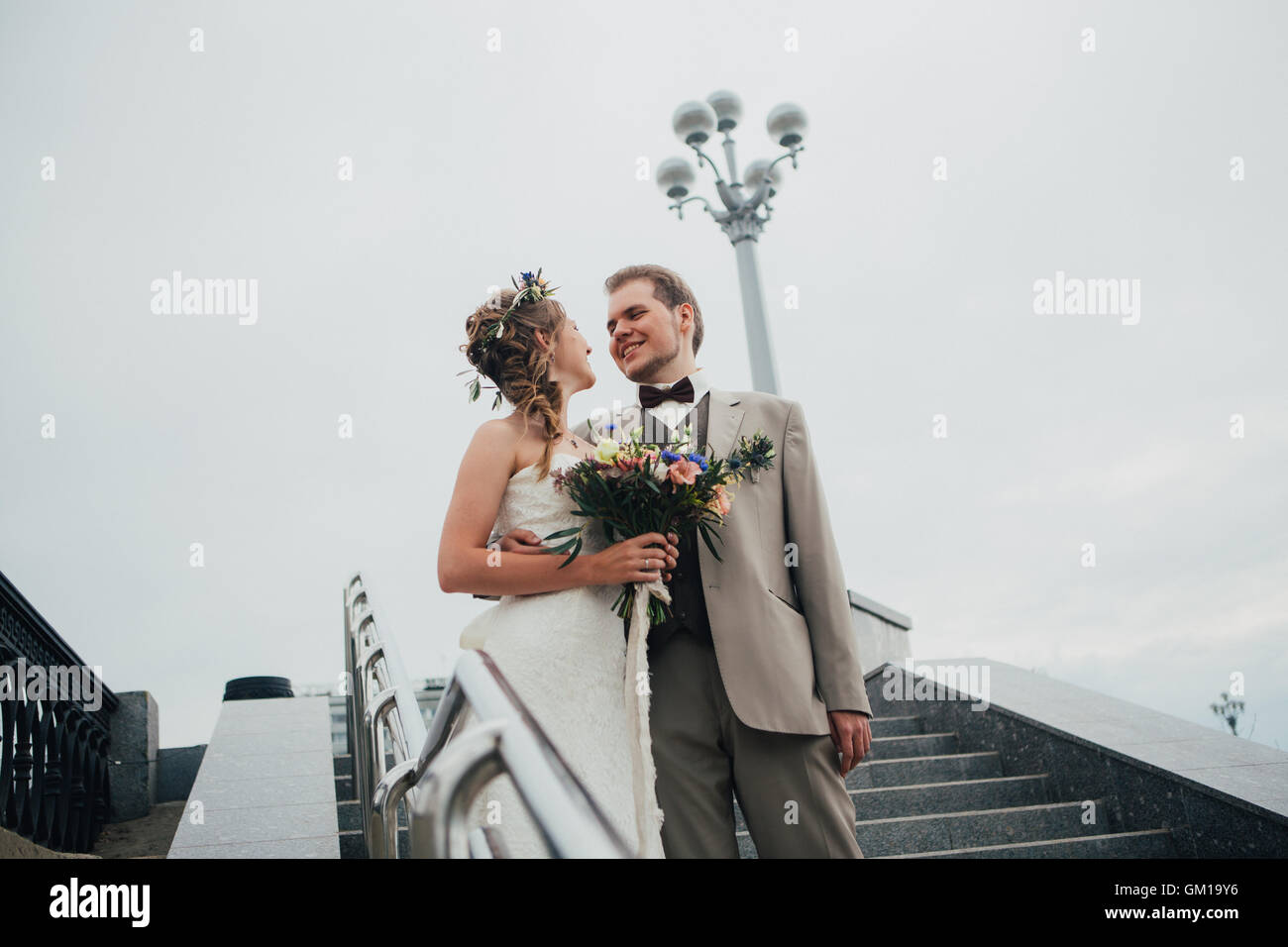 young bride and groom on the background of the stairs Stock Photo - Alamy