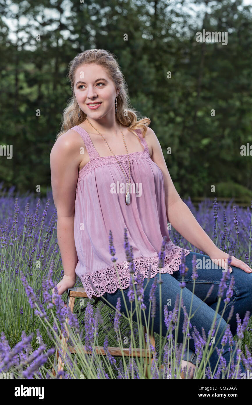 Stylish young woman enjoying a beautiful lavender field Stock Photo