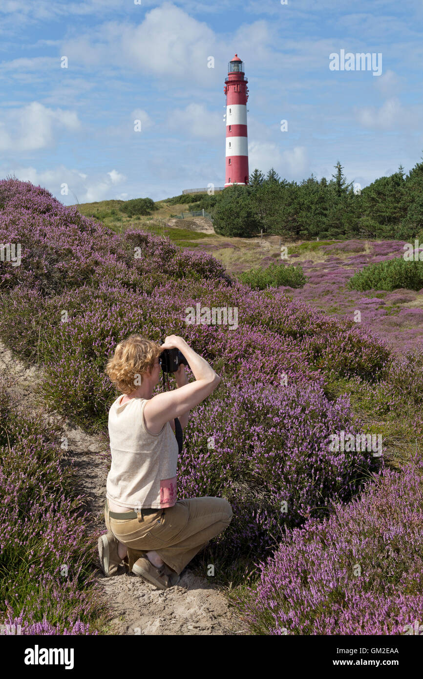 woman taking photos of the lighthouse, Amrum Island, North Friesland, Schleswig-Holstein, Germany Stock Photo