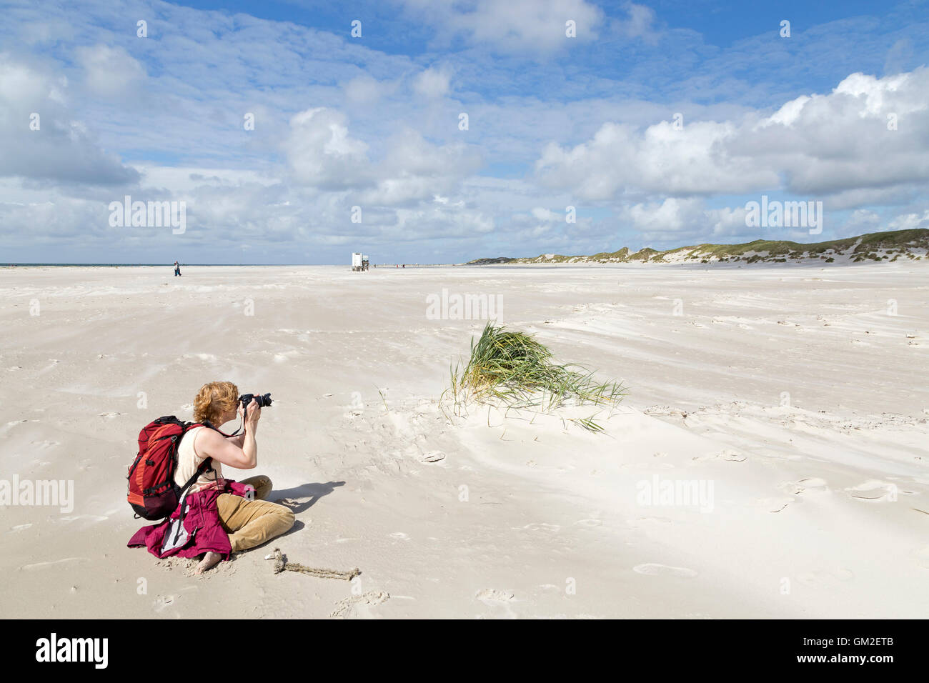 woman taking photos, Kniepsand beach, Amrum Island, North Friesland, Schleswig-Holstein, Germany Stock Photo