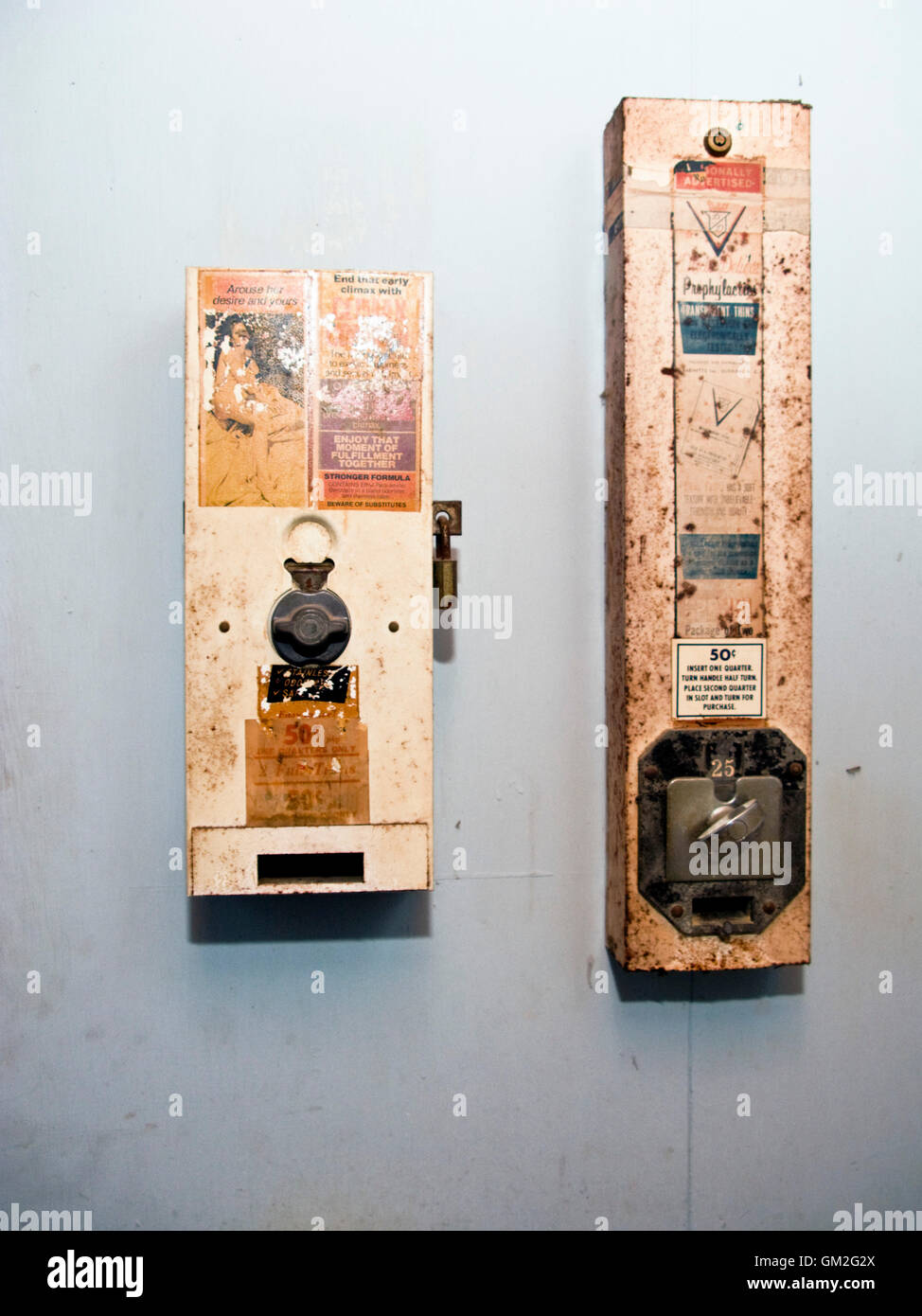Vintage condom vending machine in toilet Stock Photo