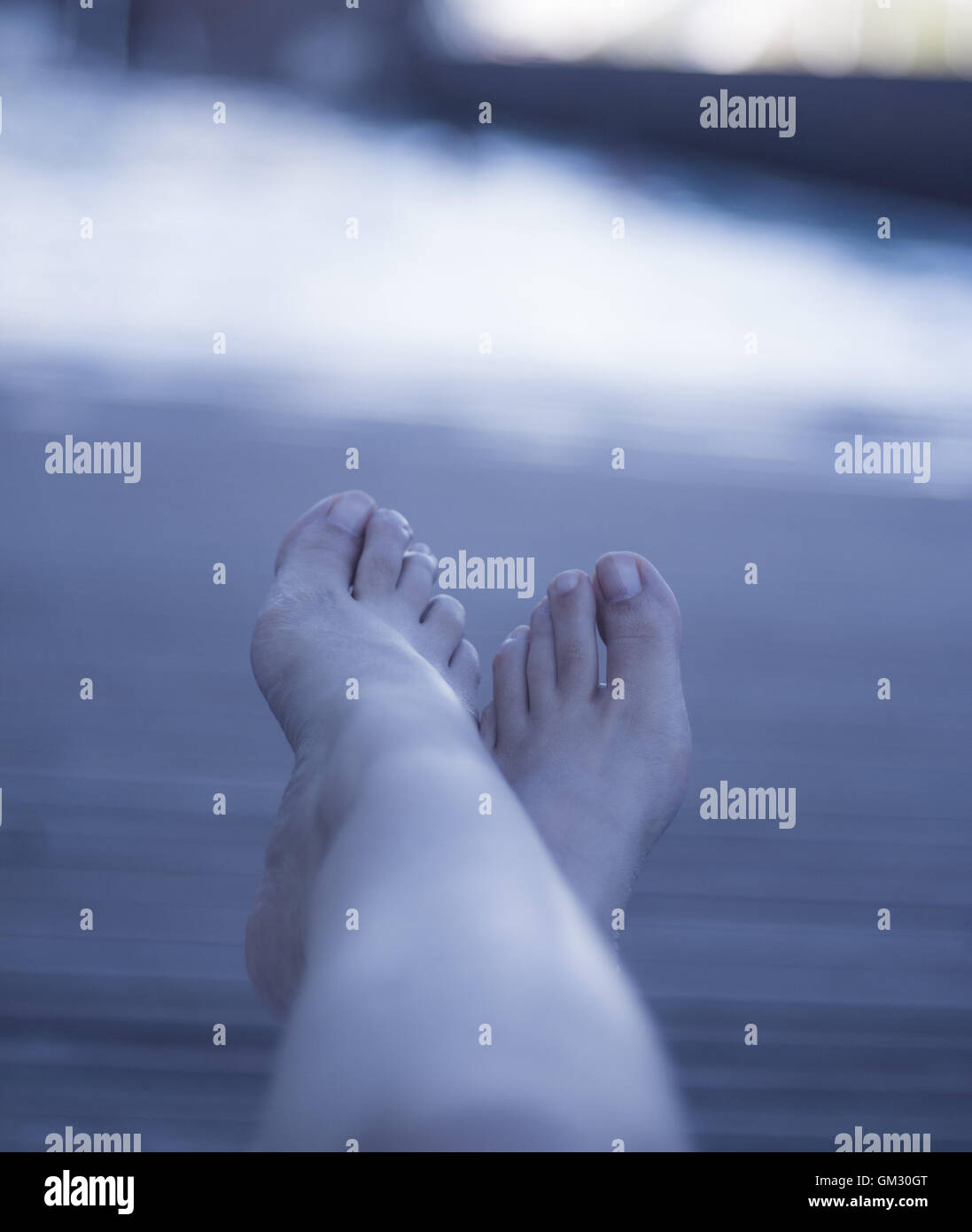 Relaxed atmosphere. Woman feet on chair at the pool Stock Photo Alamy