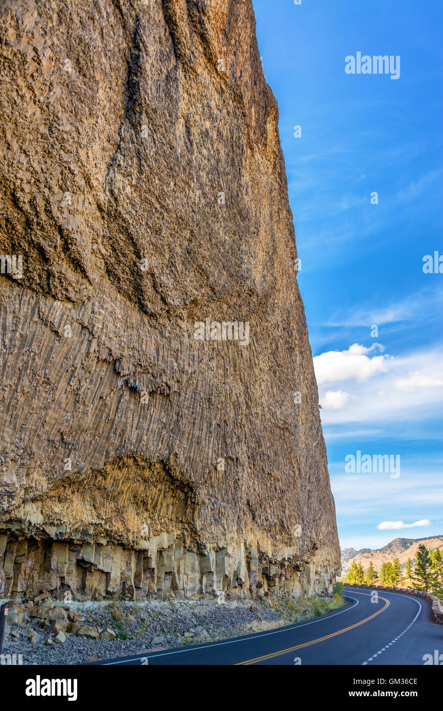 Road passing by a large cliff near Tower Fall in Yellowstone National Park Stock Photo