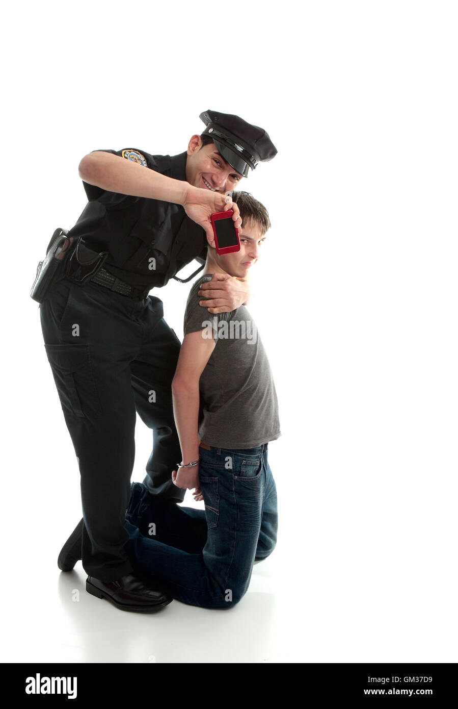 Happy policeman with apprehended teen boy Stock Photo