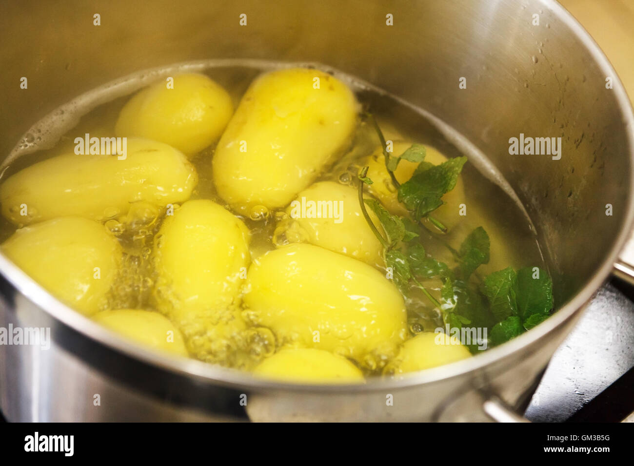 Potatoes boiling in a saucepan Stock Photo Alamy