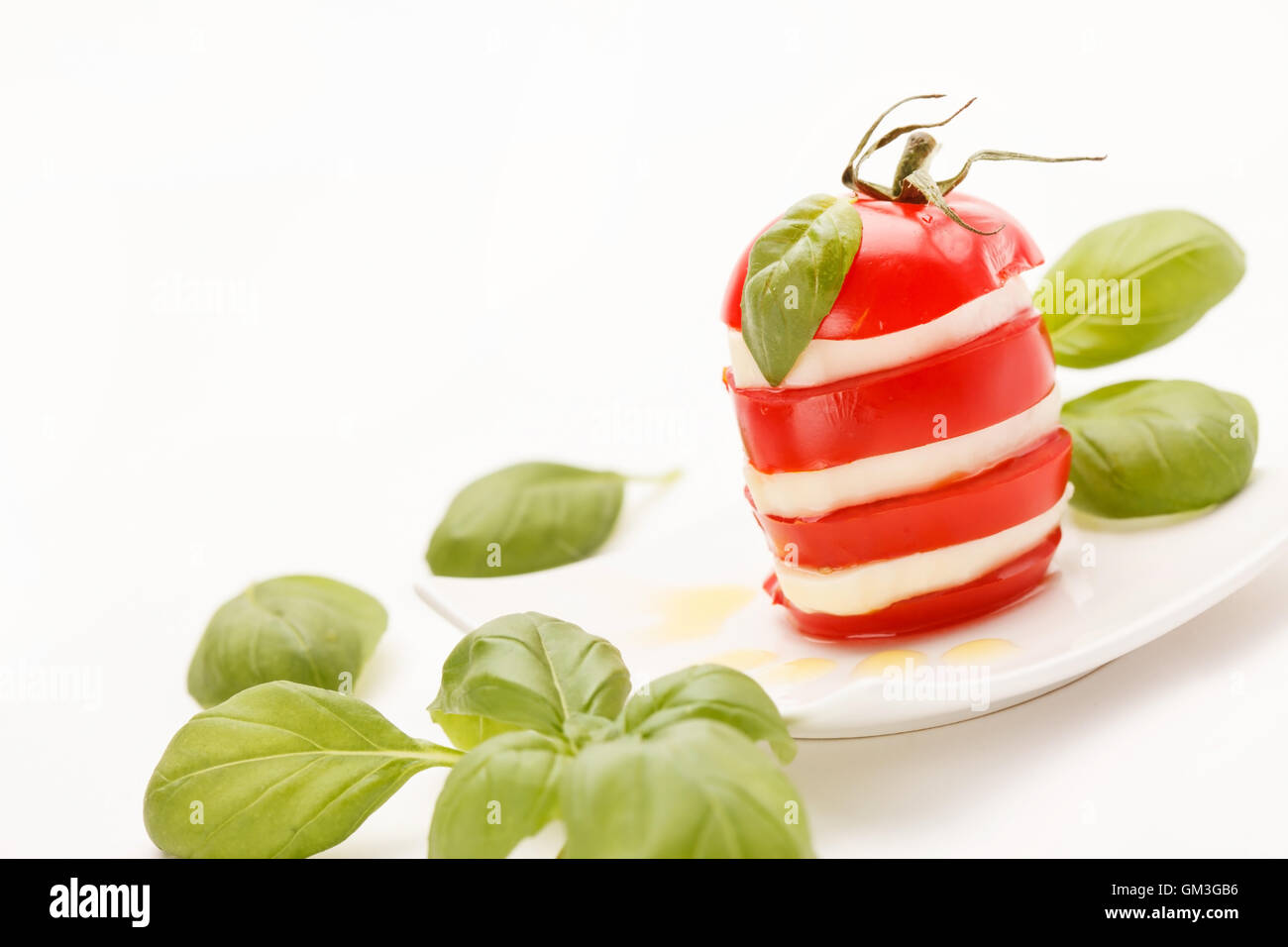 tomato and mozzarella slices decorated with basil leaves Stock Photo ...