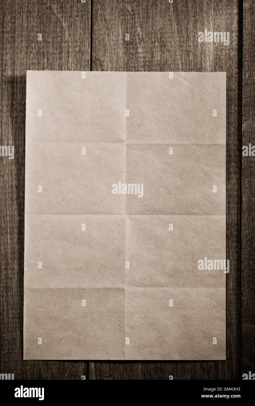 Single Paper Folded Note folded note paper on wooden background Stock Photo - Alamy