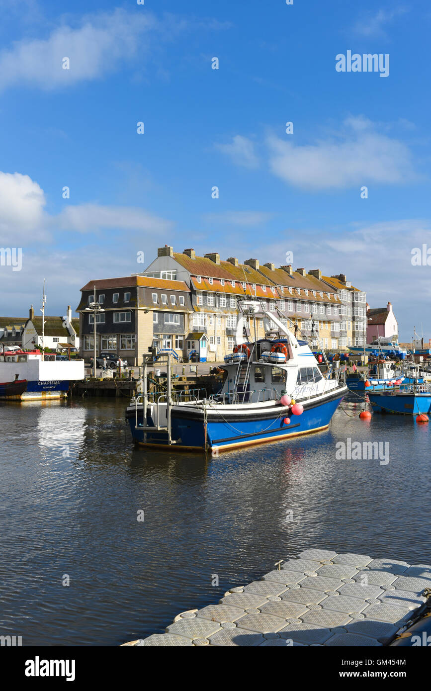 West Bay harbour with yachts and fishing boats near Bridport the gateway town for the Jurassic Coast.  Dorset, United Kingdom, UK Stock Photo