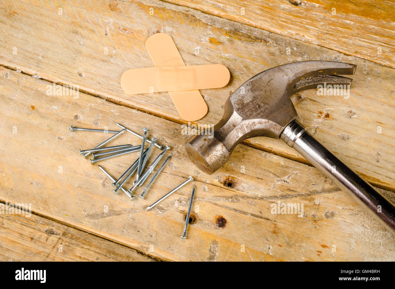 Hammer nails and band aid, a domestic DIY accident concept Stock Photo -  Alamy