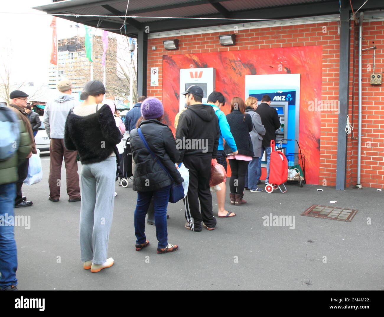 People queue for ATM in Melbourne Australia. Stock Photo