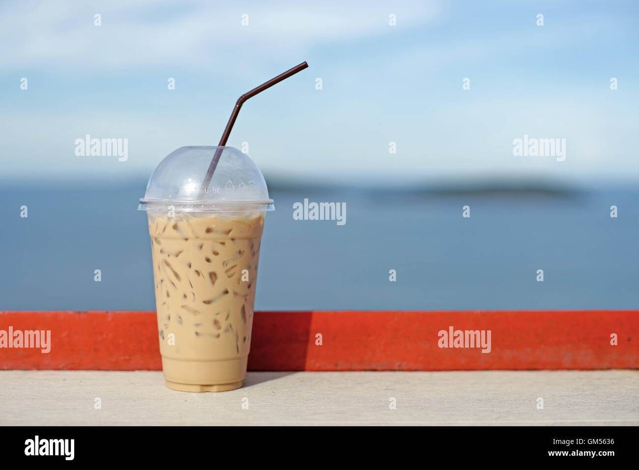 https://c8.alamy.com/comp/GM5636/ice-coffee-in-takeaway-cup-on-wooden-table-GM5636.jpg