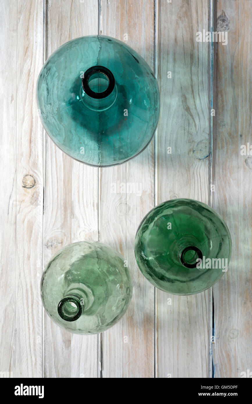 three bottles of green glass on a wooden background. Top view Stock Photo