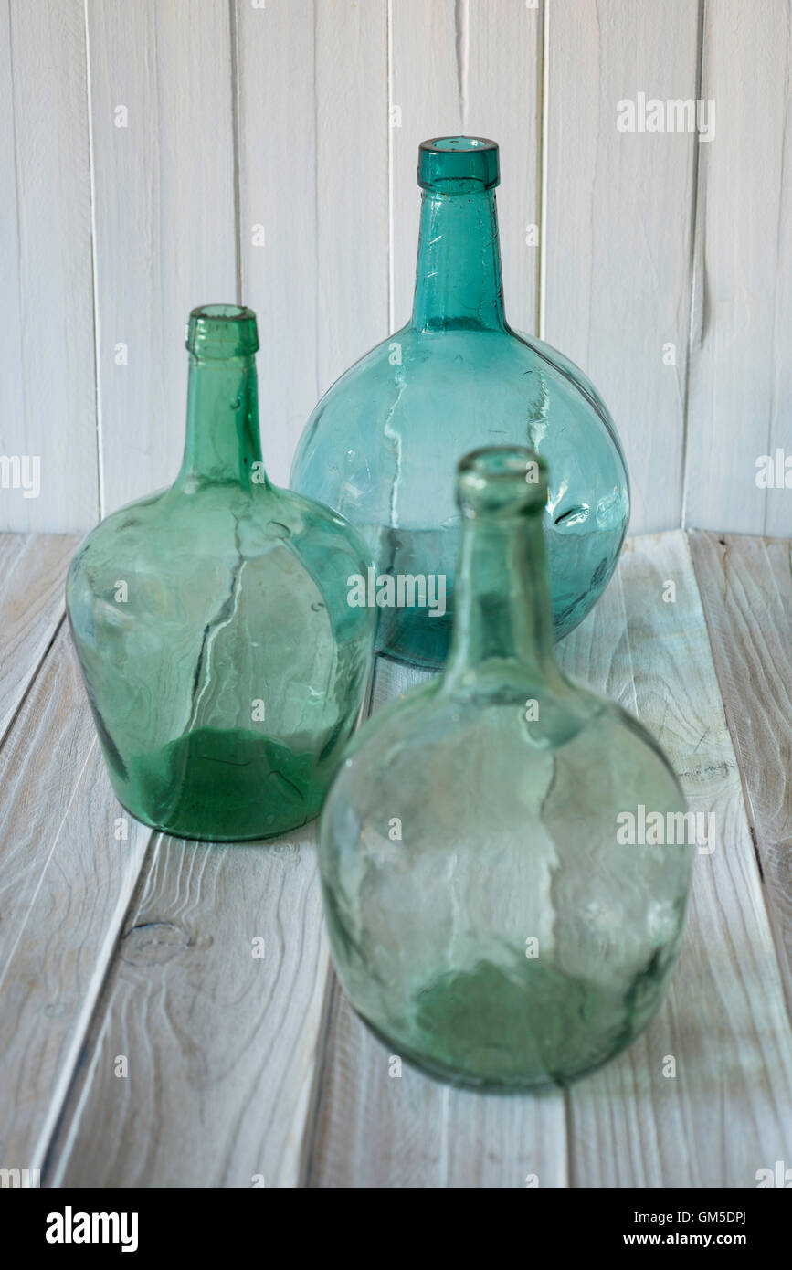 three bottles of green glass on a wooden background. selective focus Stock Photo