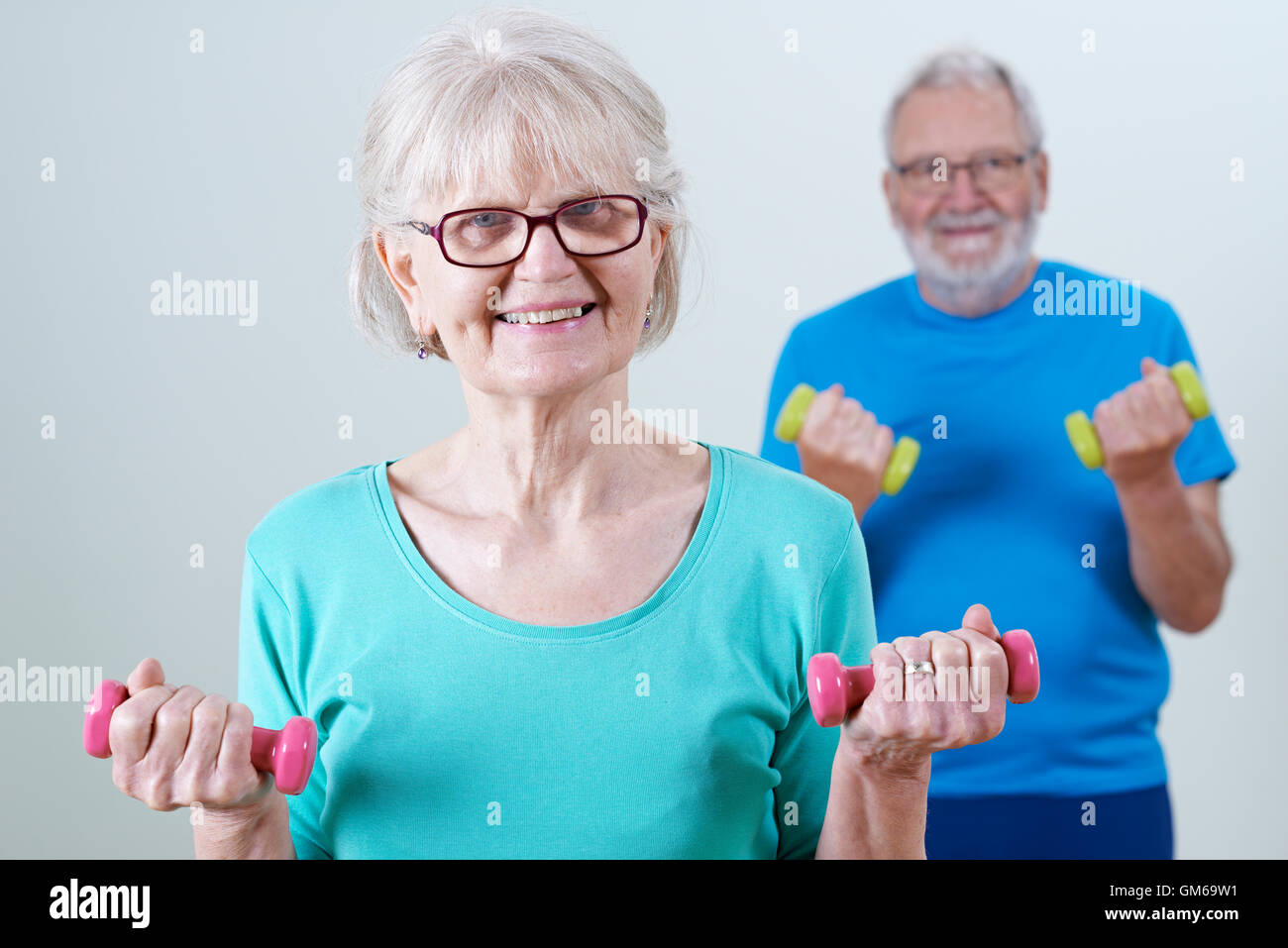 Senior Couple In Fitness Class Using Weights Stock Photo