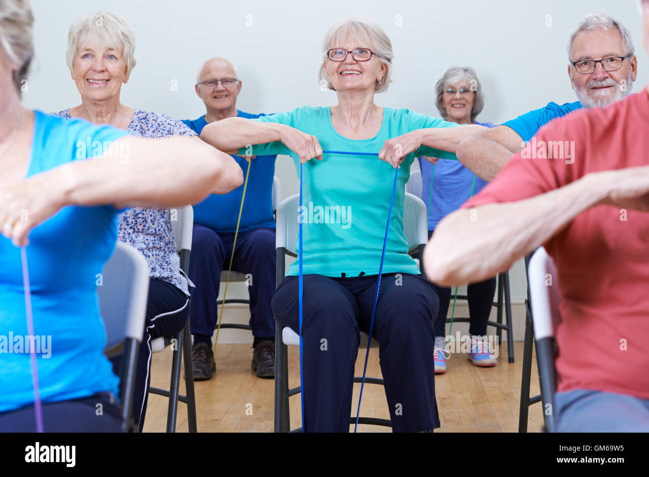 Group Of Seniors Using Resistance Bands In Fitness Class Stock Photo